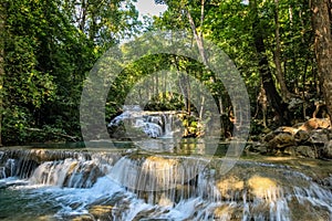 A series of beautiful waterfalls and flat pools in the dense forest of Erawan National park in Thailand