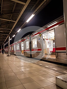 a series of commuter line train cars are transiting at the station