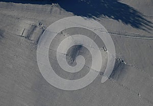 a series of hills in a row on a downhill ski course. children and adults race