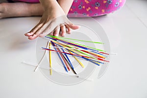 Series of kid playing pick up sticks fun game