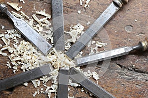 Series of many steel blades many chisels and sawdust chippings i