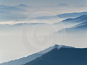 Series of mountain's and hill's profiles surrounded by autumn mi