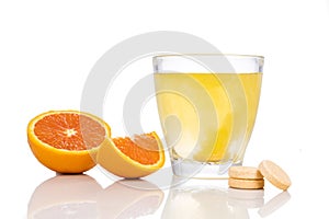 Series of orange flavored vitamin c effervescent tablet dropped and dissolve in glass of water