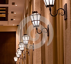 Series of retro style lamps hanging by the wall