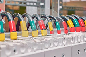 A series of several electrical wires connected to circuit breakers