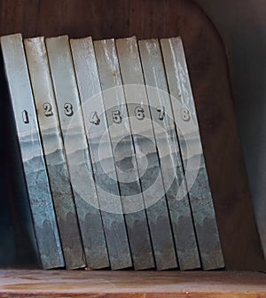 Eight volumes of old dusty books on bookshelf photo