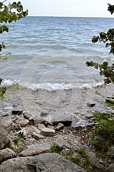 Series of waves crashing onto shoreline along Water’s Edge Trail