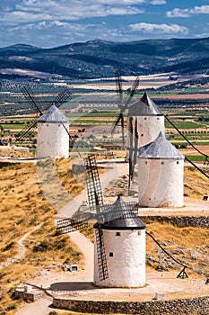 Series of windmill of Consuegra on the hill and in the background the plain of La Mancha (Spain