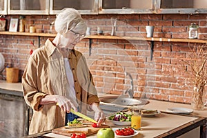 Serine old lady preparing healthy breakfast