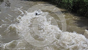 The Serio river swollen after heavy rains. Province of Bergamo, northern Italy. Brown water