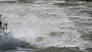 The Serio river swollen after heavy rains. Province of Bergamo, northern Italy. Brown water