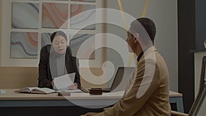 Serios African American female HR manager interviewing male job applicant