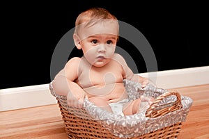 Serious 9 month old baby in basket