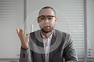 Serious african american businessman entrepreneur in suit talking to camera