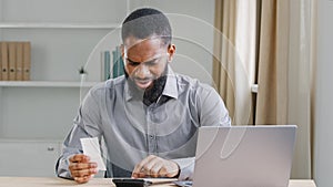 Serious African American ethnic man bearded businessman manage business company finance checking budget expenses check