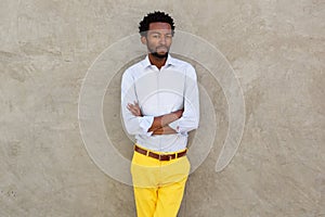 Serious african american man in yellow trousers staring