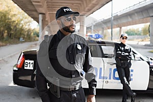 Serious african american policeman looking away