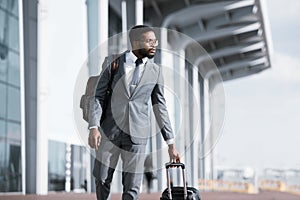 Serious African Businessman Traveling On Business Trip Walking Near Airport