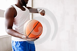 Serious african sportsman finishing to play with ball