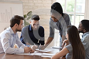 Serious african woman boss explain paperwork at group meeting