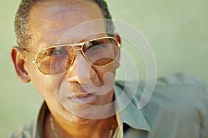Serious aged man with sunglasses looking at camera