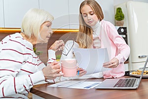 Serious aged woman sitting at the table