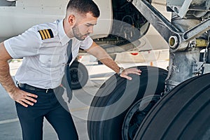 Serious airman examining the landing gear system