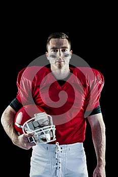 A serious american football player looking at camera