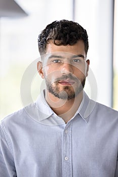 Serious Arab business man in formal shirt looking at camera