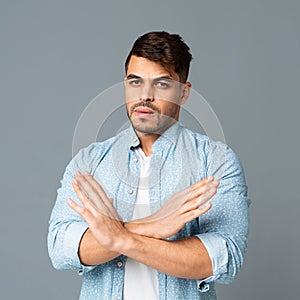 Serious Arab Man Gesturing Stop Sign With Crossed Hands