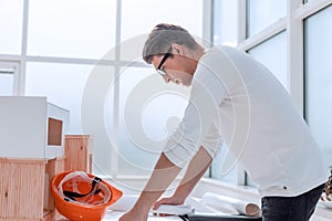 Serious architect studying the drawing of a new project.