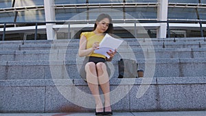 Serious asian business lady reading paperwork