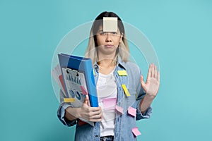 Serious Asian female office worker stops making gestures and puts his hand in front of the camera to stop something. She prepares