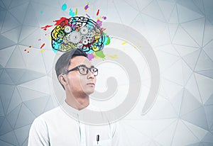 Serious Asian man, brain with gears