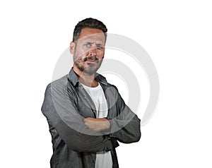 Serious and attractive man on his 40s with folded arms looking to camera smiling confident isolated on white background feeling