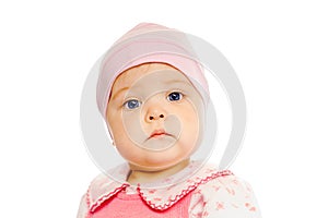 Serious baby in a pink hat on a white background