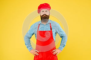Serious bearded chef. brutal male cook in hat and apron. professional man cooking. restaurant cuisine and culinary