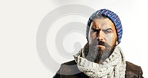 Serious bearded man in fashionable clothing. Handsome male model in stylish leather jacket, colorful hat wrapped in