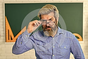 serious bearded teacher in glasses. back to school. develop logic and creativity. start the brain engine. physics