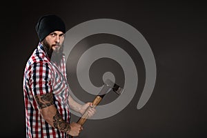 Serious bearded woodcutter holding an axe