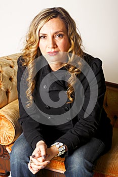Serious Beautiful Lady Sitting on Couch