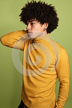 Serious black boy with Afro hairstyle in studio
