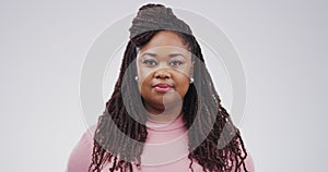 Serious black woman, face and blank stare standing isolated against a studio background. Portrait of attractive African