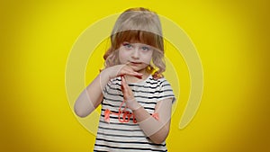 Serious blonde child girl showing time out gesture, limit or stop sign no pressure, i need more time