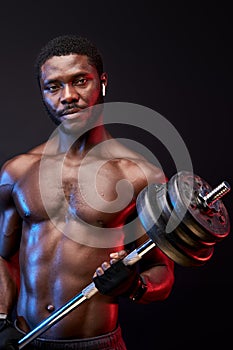 serious bodybuilder with perfect muscular body posing isolated on black