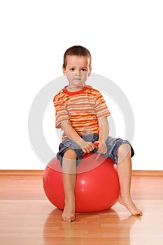 Serious boy with gymnastic ball