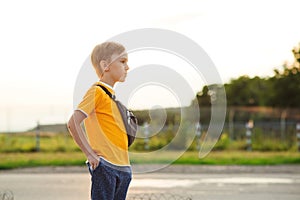 Serious boy looking into the distance at street