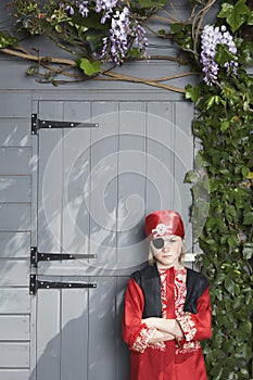 Serious Boy In Pirate Costume By Shed