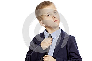 Serious boy in school uniform, isolated on white background