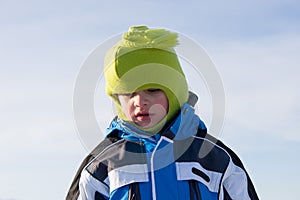 Serious boy in winter clothes